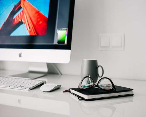 A person resting hands comfortably on a modern home office desk